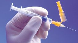 Gloved hand with needle