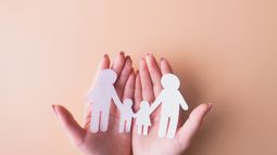 hands holding paper dolls