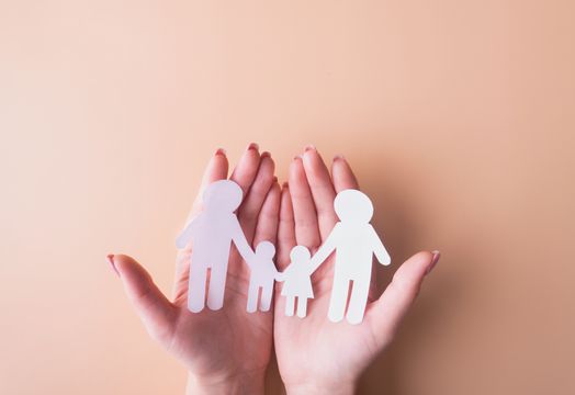 hands holding paper dolls