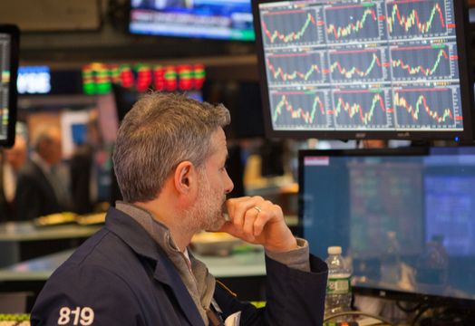 trader looks at many screens