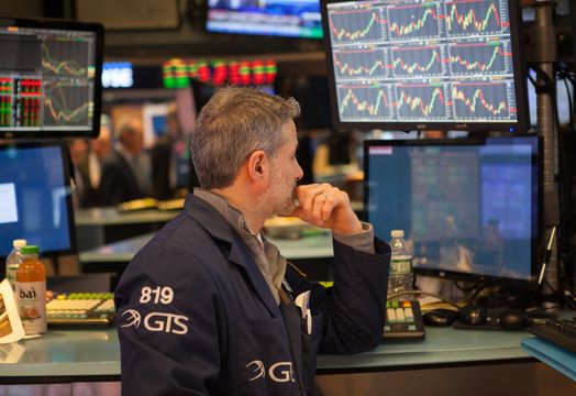 trader looks at many screens