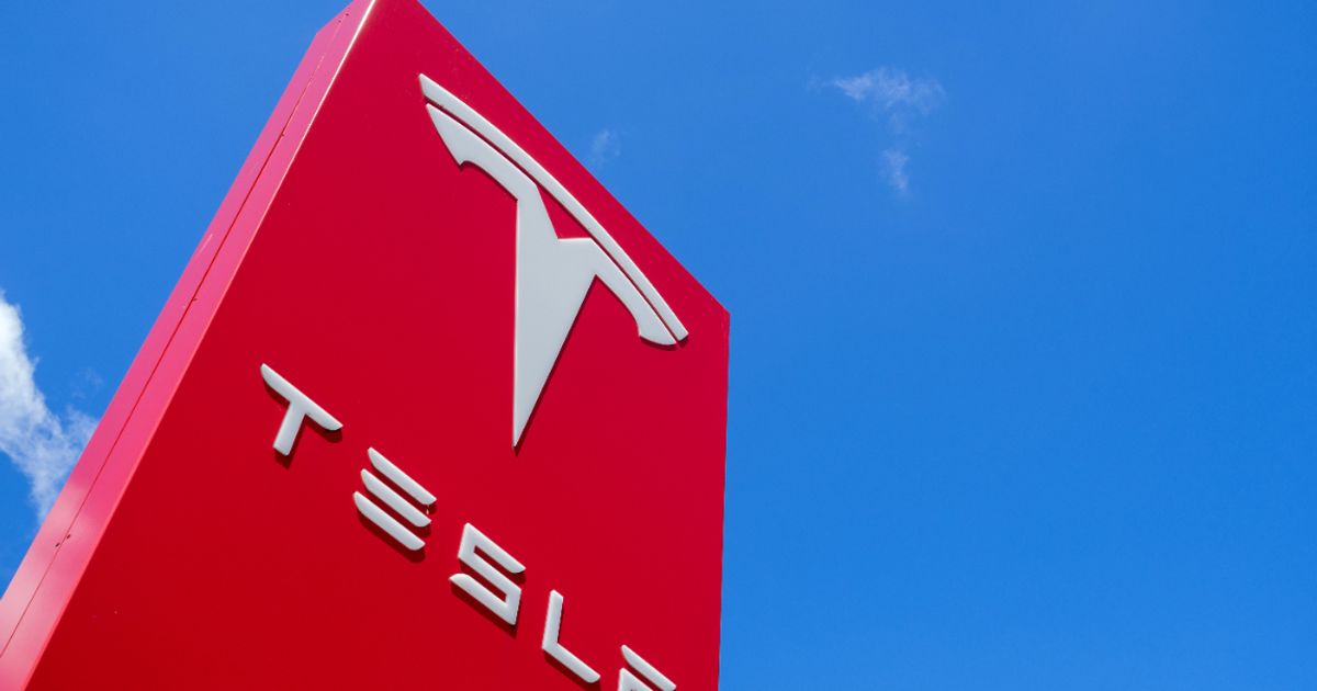 Tesla tops fourth quarter forecasts , margins improve as vehicle deliveries fall