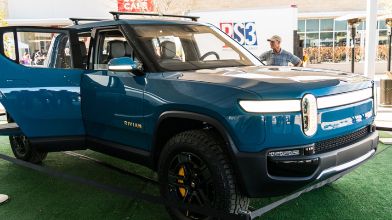Bezos-backed Rivian prices IPO at top of range | NASDAQ:AMZN