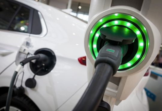electric vehicle hooked up to charger
