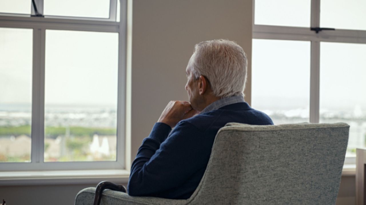 man staring out a window
