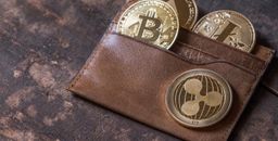 Popular cryptocurrency in leather wallet on wooden table top