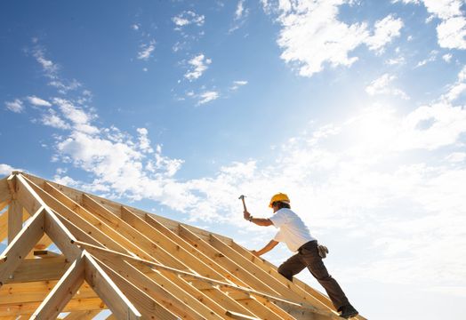 D.R. Horton - D.R. Horton stock builds momentum on 3Q earnings beat - builder working on house roof