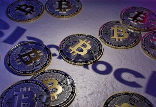 Bitcoins on top of BlackRock logo