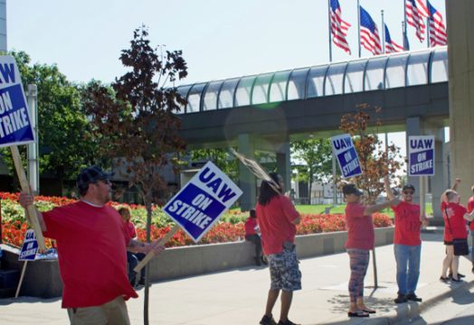 UAW members holding signs