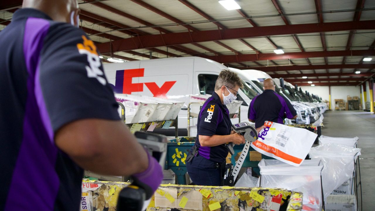 FedEx  workers and vehicles and packages