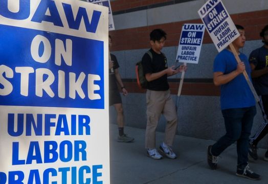 UAW members holding signs