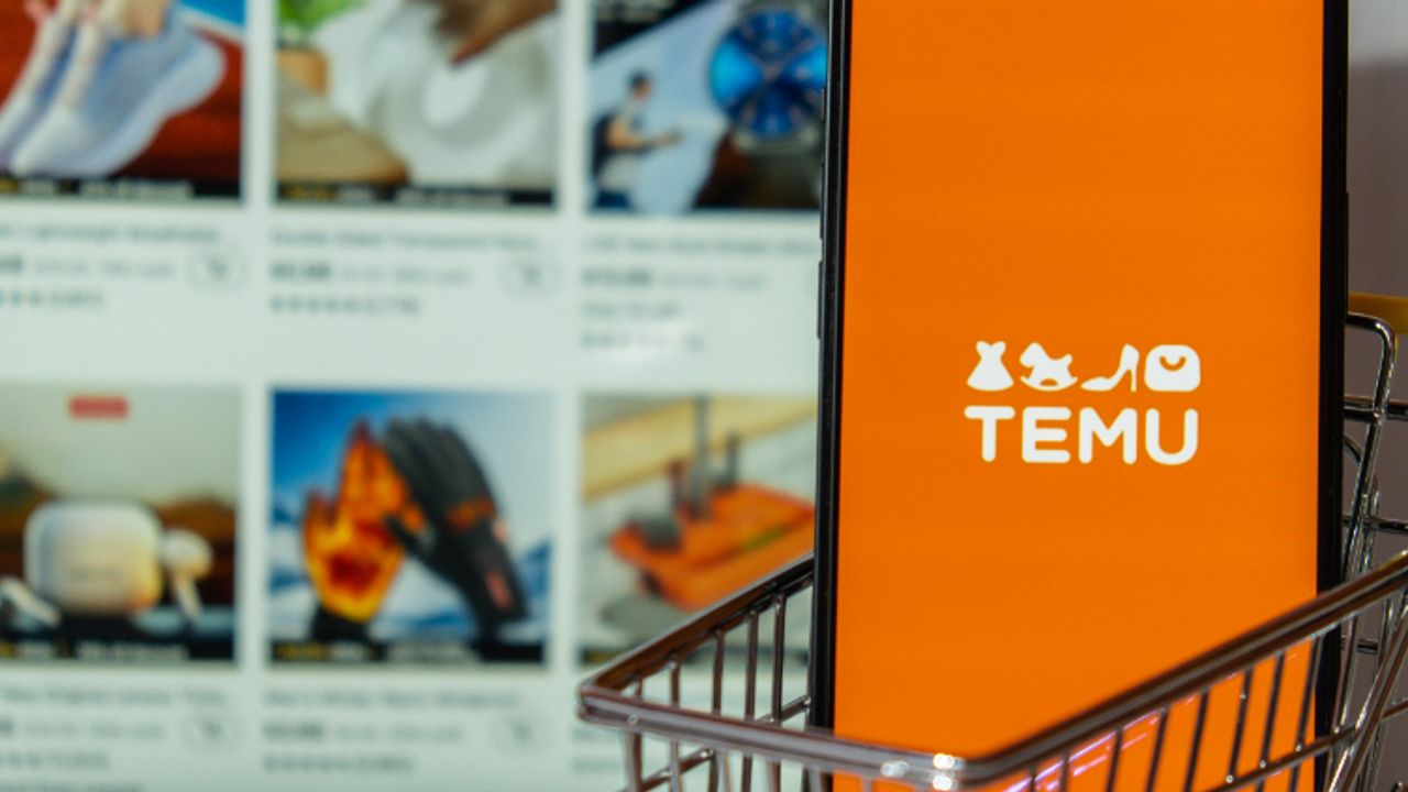 Temu poses threat to retailers targeting low-income young adults Temu app icon in screen of MacBook Apple computer laptop and mobile Iphone with shopping cart. Temu subsidiary of China based e-commerce platform Pinduoduo. Online shopping