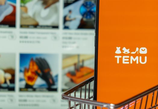 Temu poses threat to retailers targeting low-income young adults Temu app icon in screen of MacBook Apple computer laptop and mobile Iphone with shopping cart. Temu subsidiary of China based e-commerce platform Pinduoduo. Online shopping