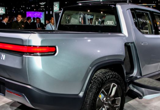 Rivian Automotive Inc - Rivian reports smaller-than-expected 3Q loss; raises vehicle production guidance